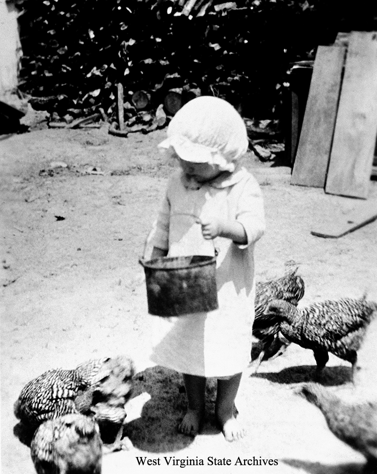 Dreama Chew feeding chickens at Sinks Grove, ca. 1920. Dreama Chew Collection, West Virginia State Archives (186109)