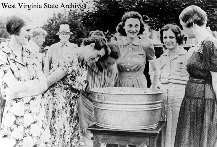 Bobbing for apples at a Weston State Hospital picnic, late 1940s. Weston State Hospital Collection, West Virginia State Archives (342606)