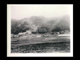 View of Glen Ferris and Electro Metallurgical Company plant from across the Kanawha River. Includes the Glen Ferris Inn. Tree covered hill behind.