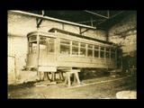 Fairmont and Clarksburg Traction Company car No. 18 on blocks inside brick building.