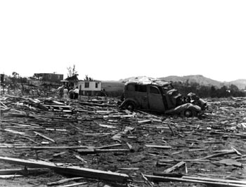 Debris, wrecked car and damaged homes