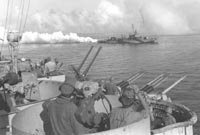 USS Cony lays a smoke screen around the West Virginia off Leyte, October 20, 1944