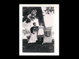 Woman and child (Minnie Taylor and Dizzy) on bench under a tree.