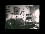 Interior of Fred Raven's room at the Hotel Richland. View of rolltop desk, pictures, and other furnishings.