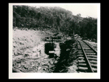 Surge basin site during the hydroelectric power construction on the New River. Adit cut and tunnel showing excavation above ledge rock for concrete arch abutments over the approach to the tunnel. New-Kanawha Power Company, Hawks Nest - Gauley Junction Development No. 136.