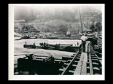 Dam during the hydroelectric power construction on the New River. Cofferdam is being extended to include blocks 20 and 21. Foundations are completed for blocks 18 and 19 inside of cofferdam in foreground. Men working. New- Kanawha Power Company, Hawks Nest - Gauley Junction Development No. 255.