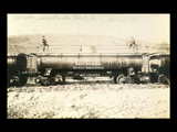 Close-up of Monongahela Valley Traction Company tank car with two men on top. Identical to 0192 02 despite different date.