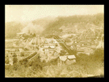 View of Monongah from hillside. Consolidation Coal Company structures, coal cars, houses.