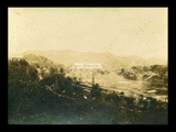 View of Mannington from hillside. Oil derricks, railroad cars.