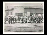 Group of stogie makers on Labor Day posed in front of the Union Automobile Company on 16th Street in Wheeling. Center cirkut of panoramic.
