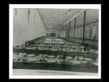 The dining hall at the state penitentiary at Moundsville. Tables set with plates, cups, and bowls, but no people in view.