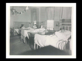 Interior view of Ohio Valley Hospital showing the men's ward with male patients in bed.