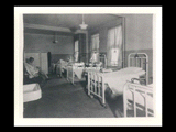Interior view of Ohio Valley Hospital showing the women's ward with women patients in bed.