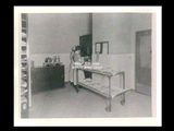 Interior view of Ohio Valley Hospital showing the diet kitchen with two women standing at counter and dinnerware on a cart.