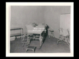 Interior view of Ohio Valley Hospital showing a delivery room with bed, stools and other furniture.