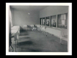 Interior view of Ohio Valley Hospital showing the nursery with three men standing at windows looking in.