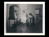 Interior view of Ohio Valley Hospital showing the viewing room with a woman sitting at a chair and a man sitting on a stool looking at x-rays.