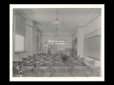 Interior view of Ohio Valley Hospital showing a nurses class room with wooden chair desks and human anatomy apparatus at far end.