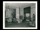 Interior view of Ohio Valley Hospital showing the reception room in the nurses residence with chairs, books in shelves, and a Christmas tree.