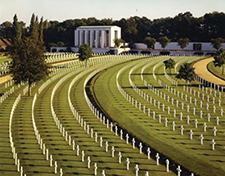 In the Cambridge American Cemetery, the only U.S. military cemetery in England, the graves are aligned like the spokes of a wheel, with the memorial building as a foal point, and the Wall of the Missing behind. Courtesy of American Battle Monuments Commission