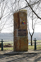 Memorial to the 5th Armored Division in Bertange, Luxembourg. The triangular insignia of the Division rests above the verbiage commemorating those who participated in the liberation of the city. Les Meloures, CC BY-SA 4.0 <https://creativecommons.org/licenses/by-sa/4.0>, via Wikimedia Commons