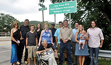 Family members gather following the bridge dedication ceremony on 11th Street in Elkins for Petty Officer Mark Edward Hutchison, who was killed Oct. 30, 1990, during a boiler-room rupture on the USS <i>Iwo Jima</i>. Shown seated in front is his father, Edward S. Hutchison, as well as siblings and other relatives. <i>Elkins Inter-Mountain</i> photo, 24 July 2017. Used with permission