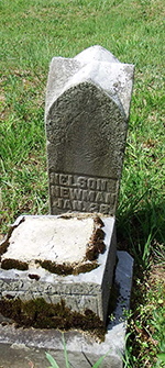 The gravestone for Nelson Newman in Welch Cemetery is off its base and deteriorating. Courtesy Cynthia Mullens