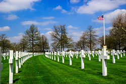 Green grass and white headstones cover the ground at Netherlands American Cemetery. Courtesy American Battle Monuments Commission