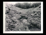 Tunnel portal at power house with men along tracks during the hydroelectric power construction on the New River. Heading is approximately 20 feet. New-Kanawha Power Company, Hawks Nest - Gauley Junction Development No. 111.