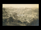 View of Farmington from hillside. Building with Underwood Supply Company Department Store sign at right.