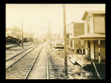 View down tracks in Mt. Clare. Buildings along tracks.