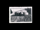 View of Meadow River Lumber Company engines No. 6 and 7 in front of building. From small red photo album.