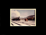 Log train moving along tracks in winter. From small red photo album.