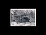 Logging scene. Steam loader No. 5 of the Spruce Lumber Company on Cheat Mountain near Spruce. Workers standing on or beside loader. From small red photo album.