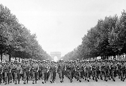 American troops of the 28th Infantry Division march down the Champs-Elysees in Paris in the 