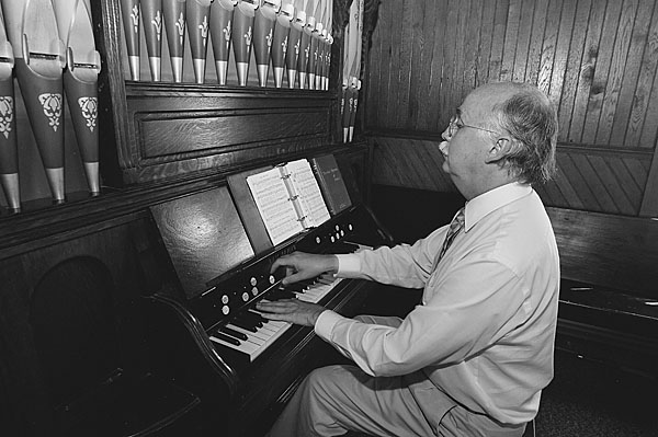 Richard Ruddle plays a reed organ