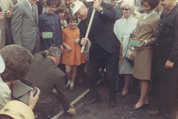 Governor Hulett Smith drives gold spike on top of Bald
Knob