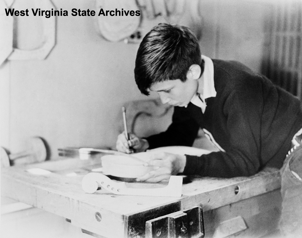 Student making a fiddle as part of a music class, Arthurdale, n.d. Harry Carlson Collection, West Virginia State Archives (339405)