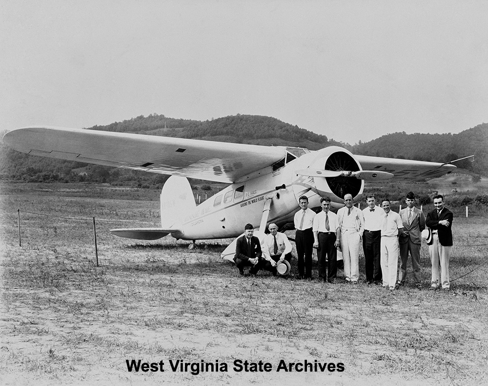 Wiley Post, fourth from left, and others, posing with his Winnie Mae, a Lockheed Model 5C Vega at Wertz Field, Institute, ca. 1934.  Beulah Stark Collection, West Virginia State Archives (022603)