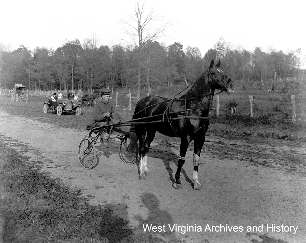Horse and manned sulky with an automobile in the background at Berkeley Place race track (old fair ground), n.d. Jeff Hollis Collection, West Virginia State Archives (063209)