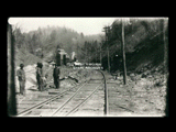 Men working on railroad tracks with coal tipple in the background. Wilcoe No. 1 shaft mine according to information from database user.