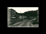 Street scene at Northfork with railroad tracks running in front of buildings. From Wisconsin Historical Society.