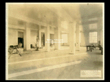 Senate Judicial offices in Building 1 (West Wing) during construction of the Cass Gilbert WV State Capitol building. Worker is on ladder painting support column. Another is painting the wall and a third worker is at a window.