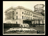 Stonework of the Main Building and girder of dome during construction of the Cass Gilbert WV State Capitol building. Railroad car at left. East side.