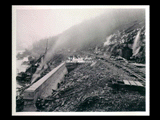 Tunnel intake during the hydroelectric power construction on the New River. View looking downstream showing backfill being placed over completed tunnel intake. Front of intake shown in center and upstream retaining wall at left. New-Kanawha Power Company, Hawks Nest - Gauley Junction Development No. 353.