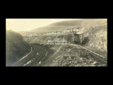 Construction on the Wolf Summit extension. Steam shovel, houses, railroad track.