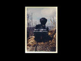 View of front of Shay engine No. 5 traveling through a wooded area. From small red photo album.