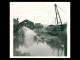 Load of logs being dumped into pond at the Meadow River Lumber Company. From red 3-ring notebook.