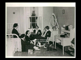 Five students in a bedroom at Mount de Chantal Visitation Academy in Wheeling. Waverly Wafer box on floor. Books on desk include Doctor Zhivago. L-R: Joan Leonard, Judy Herndon, Theresa Gurrera, Callie Jones, and Judy Hazlett. Note: Used in 1959 yearbook.