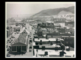 Center Market in Wheeling. Snow on roof tops. Bridge in distance.